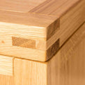 Corner view of the Abbey Light Oak Blanket Box by Roseland Furniture