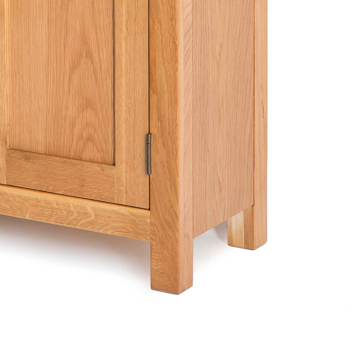 close up of the wooden base on the Surrey Oak 3 Drawer Sideboard by Roseland Furniture