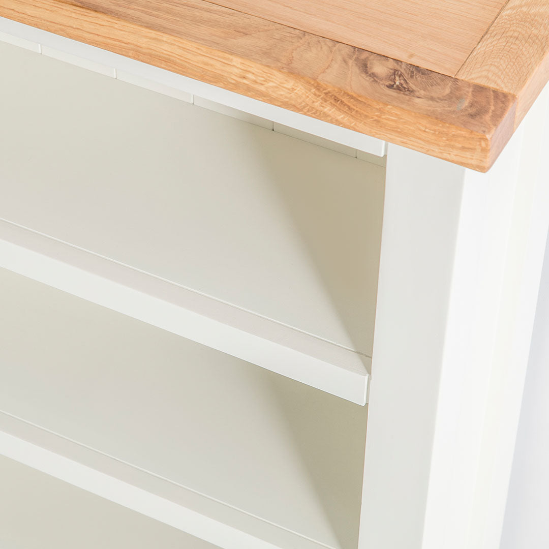 Close up of the painted white wooden frame on of the Farrow White Low Bookcase 