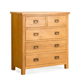 A wooden chest of drawers with six visible, closed drawers featuring round metal handles, against a white background.