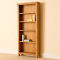 Light oak bookcase with five shelves, holding books.