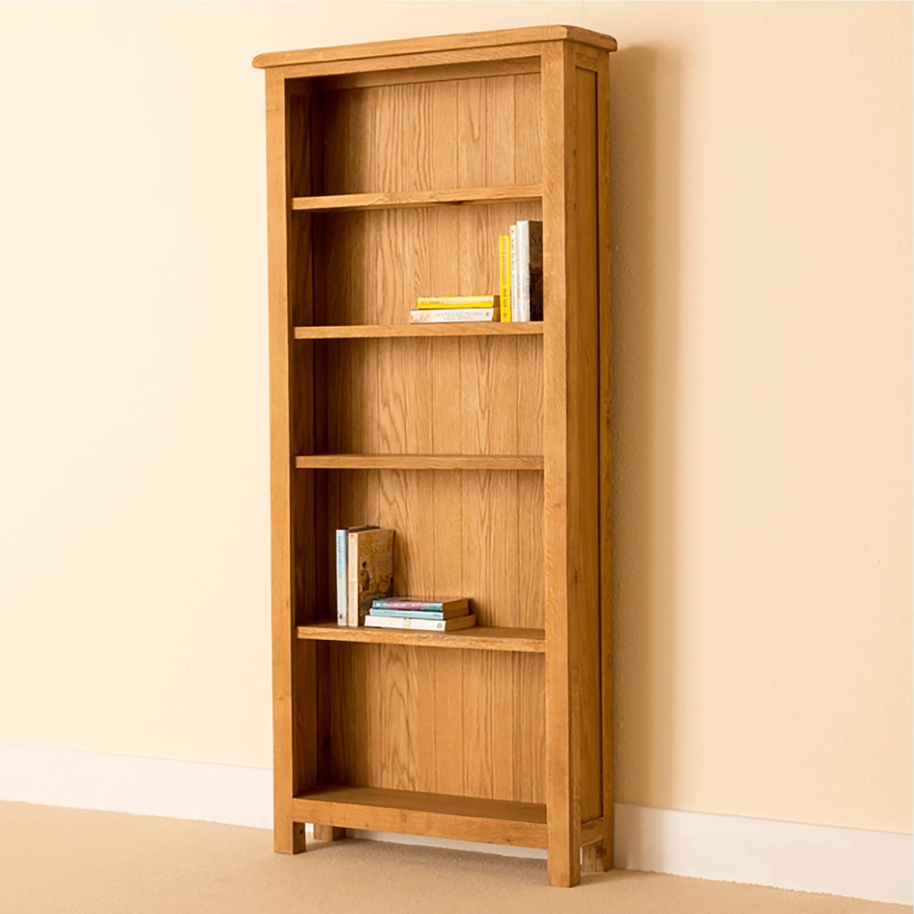 Light oak bookcase with five shelves, holding books.