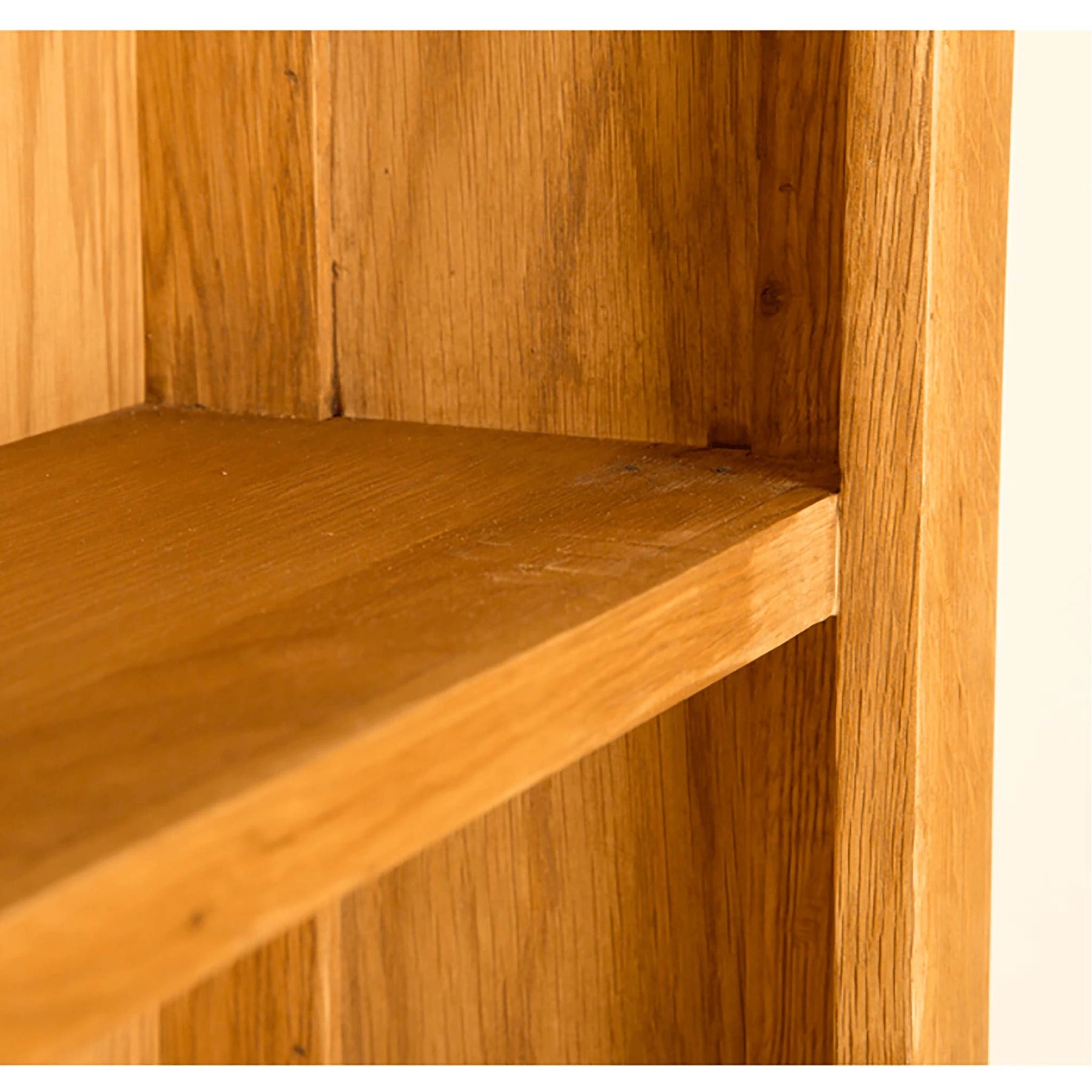Light oak bookcase shelf detail; showing wood grain and construction.