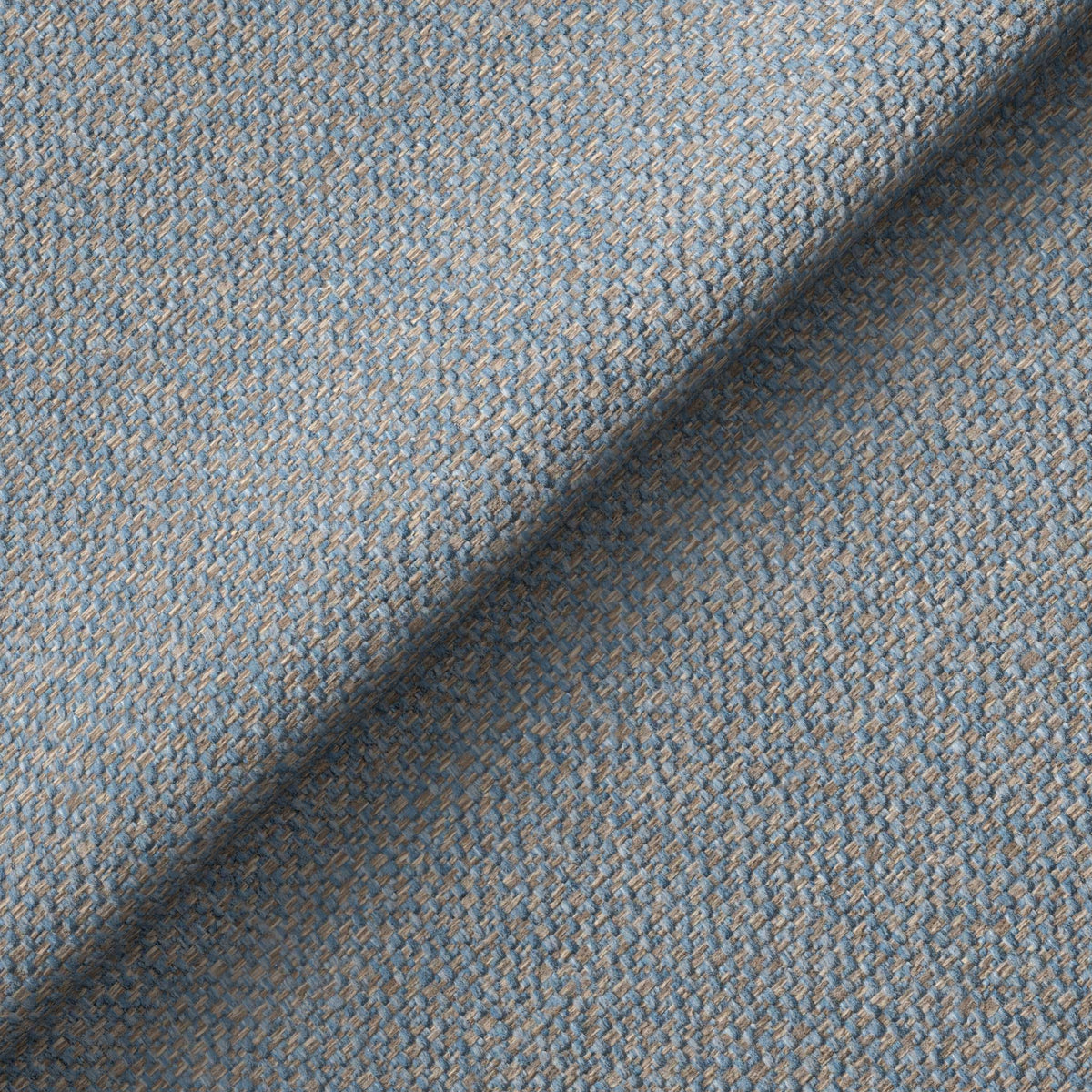 Textured fabric with a diagonal weave pattern in shades of blue, partly folded, creating a shadowed area on a flat surface.