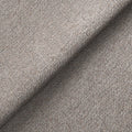 Folded grey textured fabric with a pattern of interwoven threads, creating a tactile and visually distinct surface.
