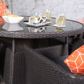 Malaga 4 Seat Deluxe Stacking 110cm Rattan Dining Set close up of glass top