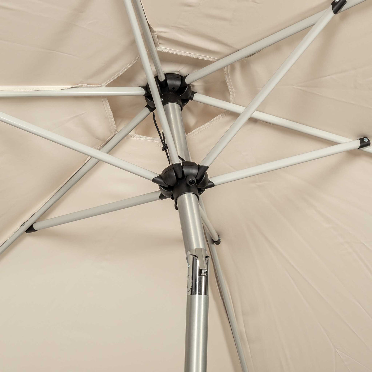 close up of the tilting mechanism on the 2.5m Crank & Tilt Ivory Garden Parasol with Brushed Aluminium Frame