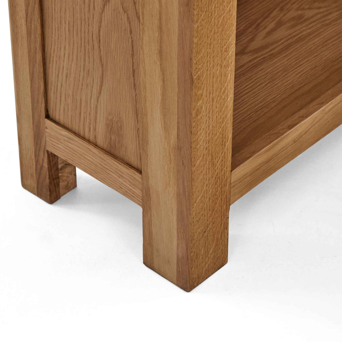 Zelah Oak Narrow Bookcase - Close up of lower shelf and feet
