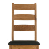 Wooden chair with black cushioned seat and ladder-style back.