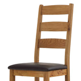 Wooden chair with dark brown leather seat and ladder-back design.