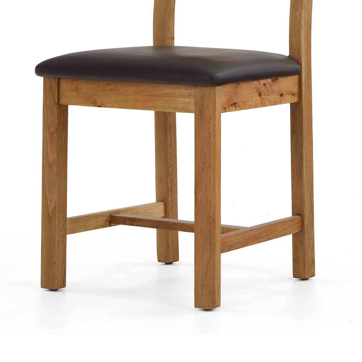 Oak chair with brown leather seat.