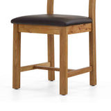 Oak chair with brown leather seat.