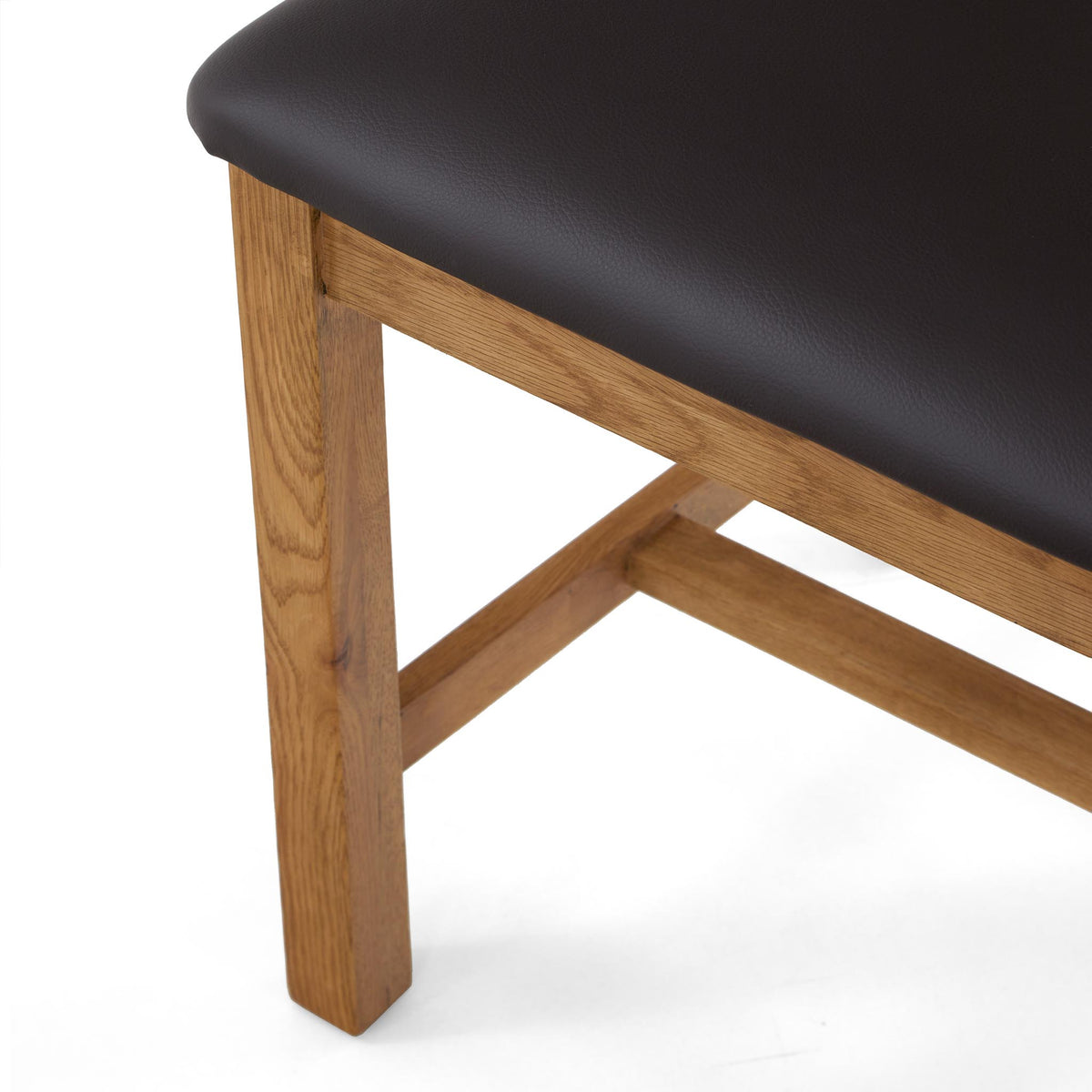 Dark brown leather seat atop light oak wood chair legs.