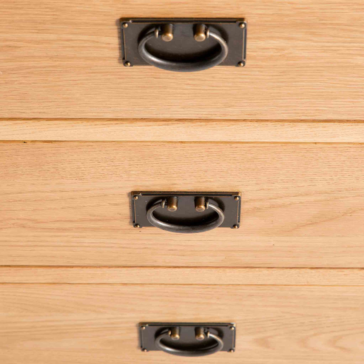 close up of brass drawer handles on the Surrey Oak 3 over 3 Chest Of Drawers