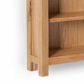 London Oak Slim Bookcase - Close up of bottom shelf and feet of bookcase
