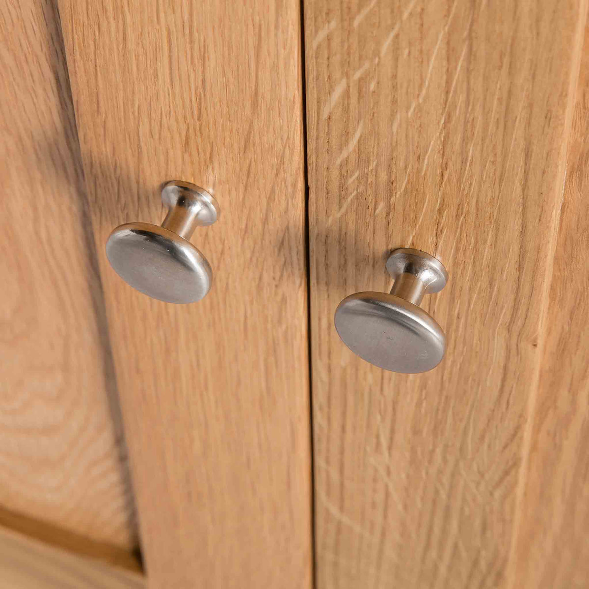 close up of the metal door knobs on the The London Oak Cupboard
