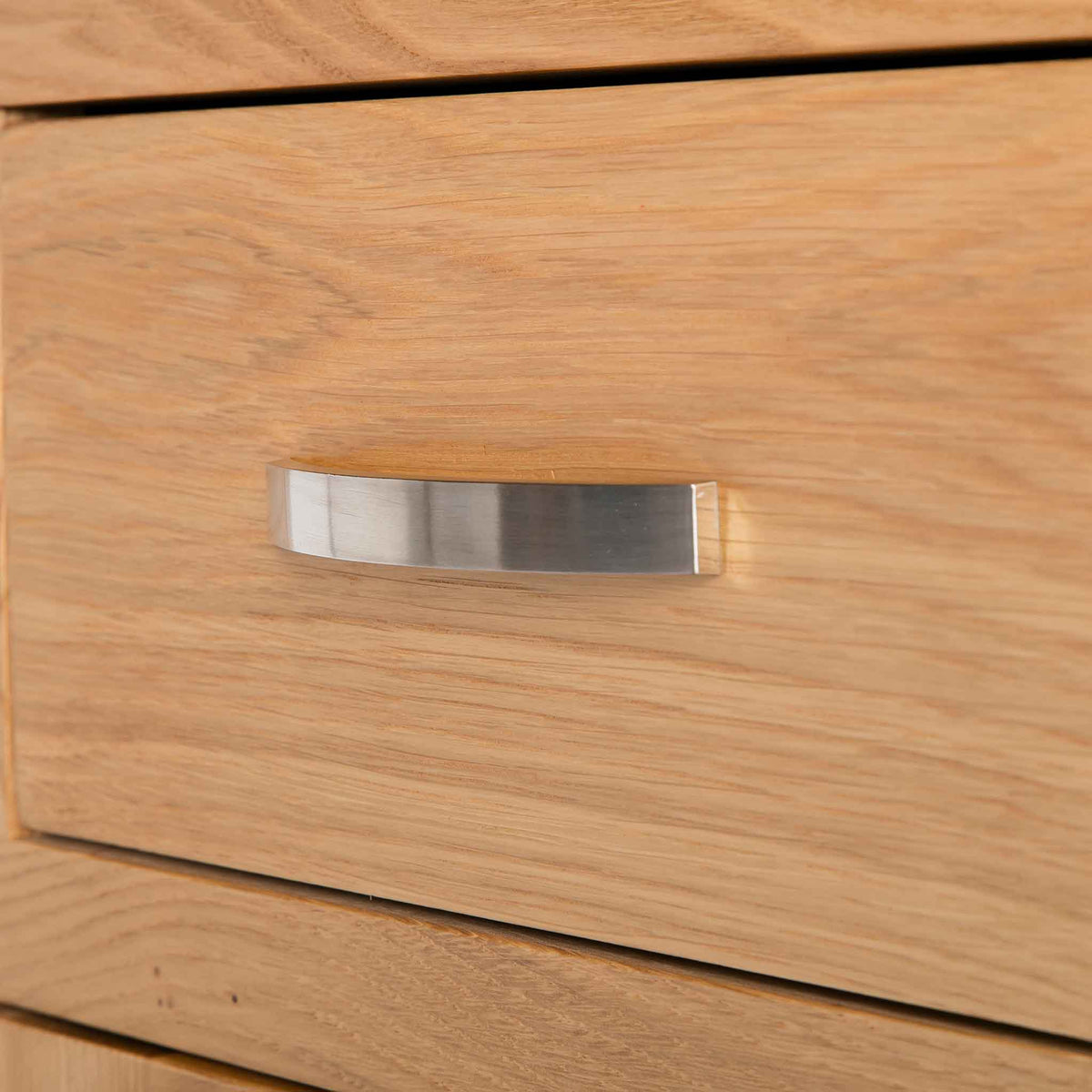 close up of contemporary metal handle on the London Oak Mini Sideboard by Roseland Furniture. 