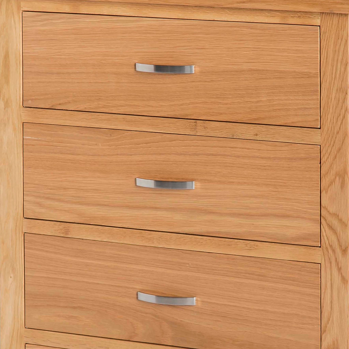 A wooden chest of drawers with three closed drawers, each featuring a horizontal silver handle, set against a neutral background.