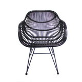 A black wire-frame modern chair sits idle, featuring a curved, grid-like seat and backrest, standing on thin metal legs against a white background.