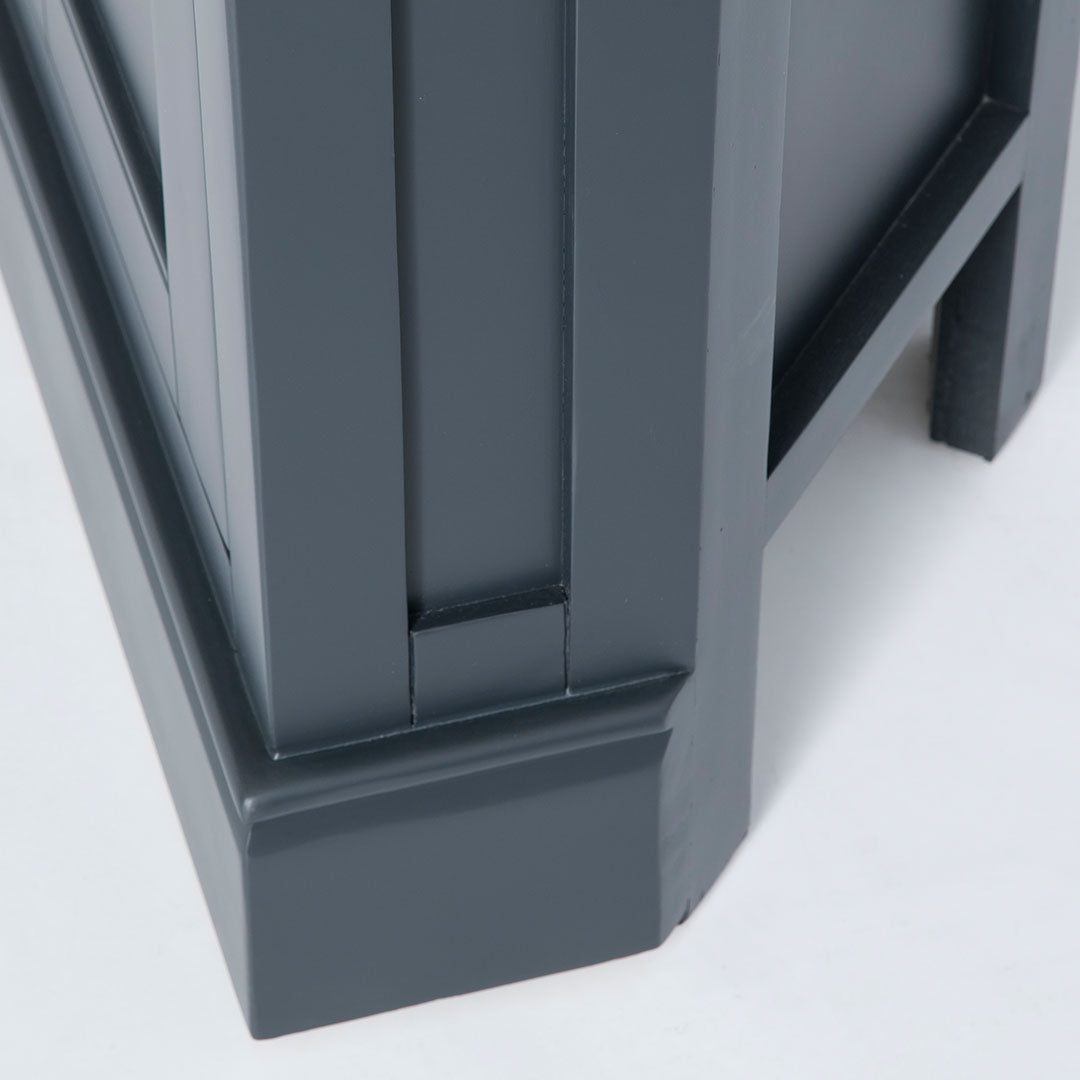 Close up of the solid wood corner base on the Chichester Charcoal Black Corner Cupboard
