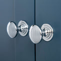 Close up of the silver door handles on the Chichester Stiffkey Blue Corner Cupboard