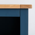 Close up of the oak top egde and blue painted frame on the Chichester Stiffkey Blue Grey Low Bookcase