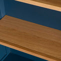 Close up of the oak shelves on the Chichester Stiffkey Blue Grey Low Bookcase