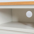 Close up of the open shelf on the Chichester Ivory Small TV Stand