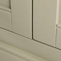 Close up of the painted green solid wood frame on the Chichester Ledum Green Corner Cupboard