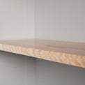 Close up of the oak fixed shelf edge on the Chichester Chester Grey Low Bookcase