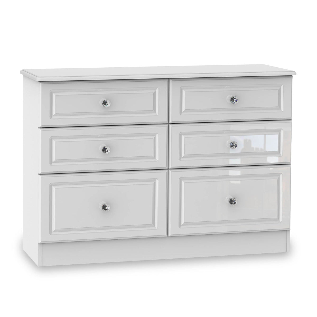 A white six-drawer dresser with silver knobs stands stationary against an isolated white background.