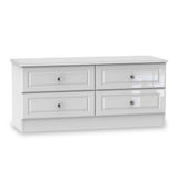 A white, low-profile TV stand with two shelves and four drawers, adorned with glass knobs, positioned against a white background.