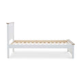 A white wooden single bed frame with a slatted base, standing idle, against an isolated background.