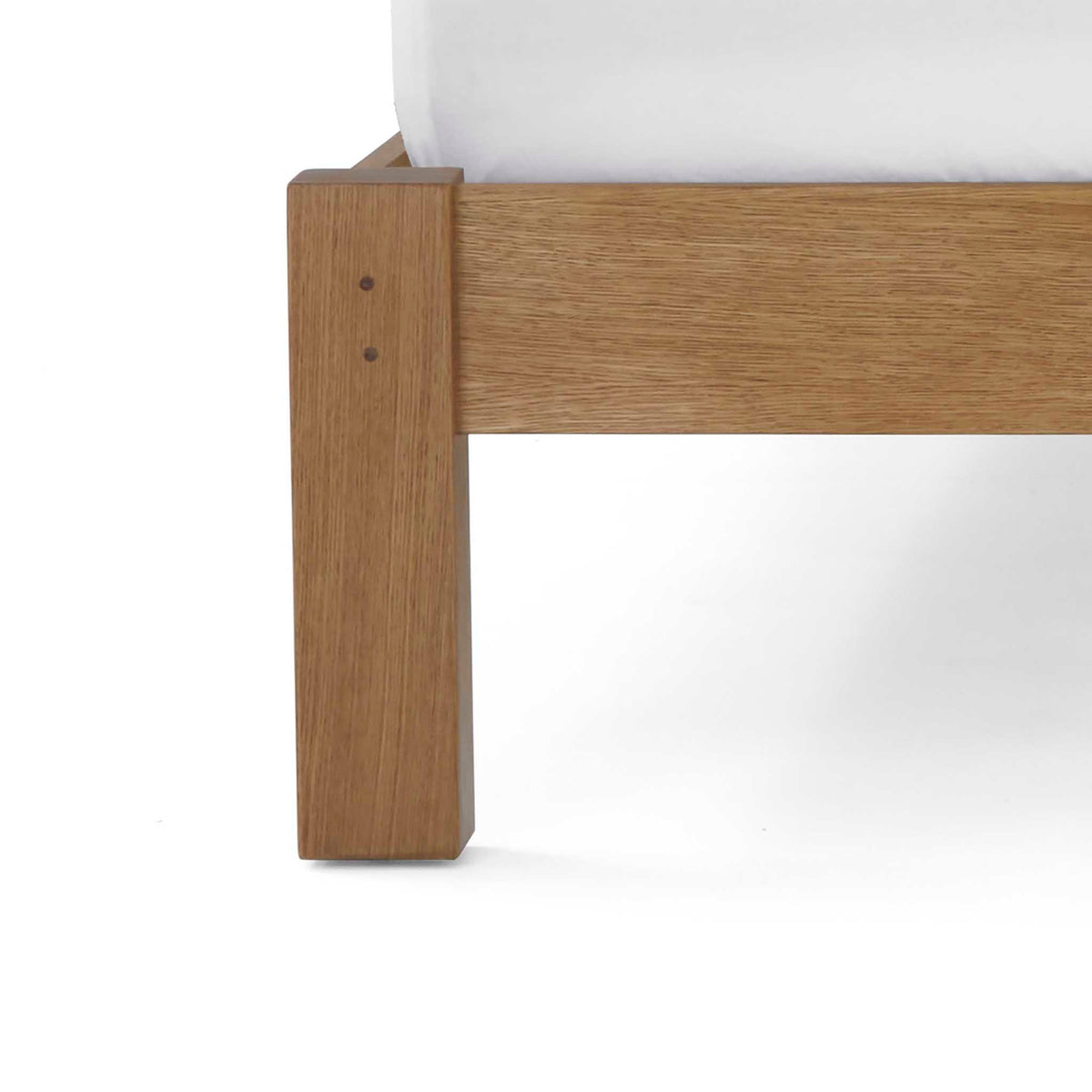close up of solid wood frame leg on the Broadway Upholstered Bed Frame