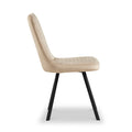 A beige upholstered chair with a quilted pattern on a white background, featuring angular black legs.