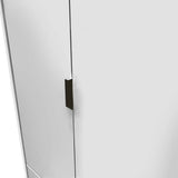 A minimalist fridge with a sleek design, featuring a dark, vertical handle on a white door, represents modern kitchen appliances.