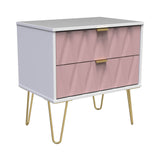 A pink and white modern chest of drawers with golden handles and angled legs, isolated on a plain background.