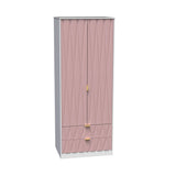 A pink fabric-covered wardrobe with gold handles stands against a white background. It features drawers at the bottom and a curtain-like front.