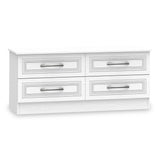 A white wooden sideboard with four drawers, detailed with patterned inlays and metal handles, against a plain background.
