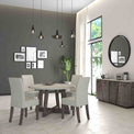 Lifestyle image of the Saltaire Grey Upholstered Fabric Dining Chair with round dining table