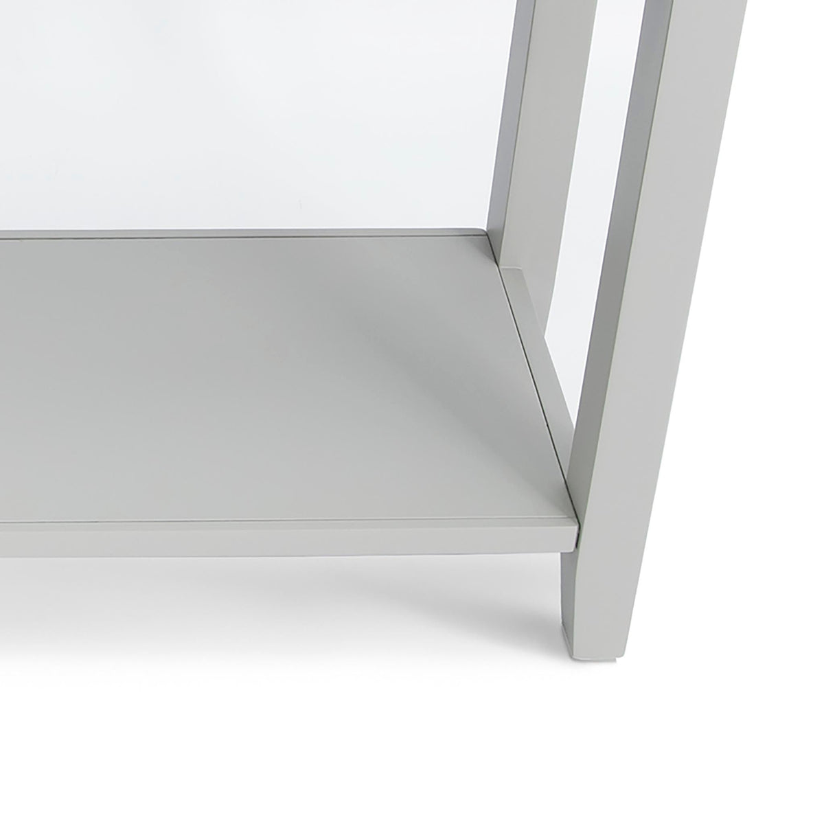 A modern, minimalist white table corner, showcasing its sleek lines and flat surfaces, set against a plain, homogenous background.