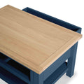 Wooden lid partially covering a blue box, suggesting a storage function, with a simplistic modern design.