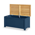 A blue storage bench with hinged natural wood lid partially open against an isolated background.