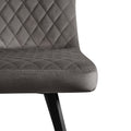 A grey upholstered chair with diamond stitching, positioned against a white background.