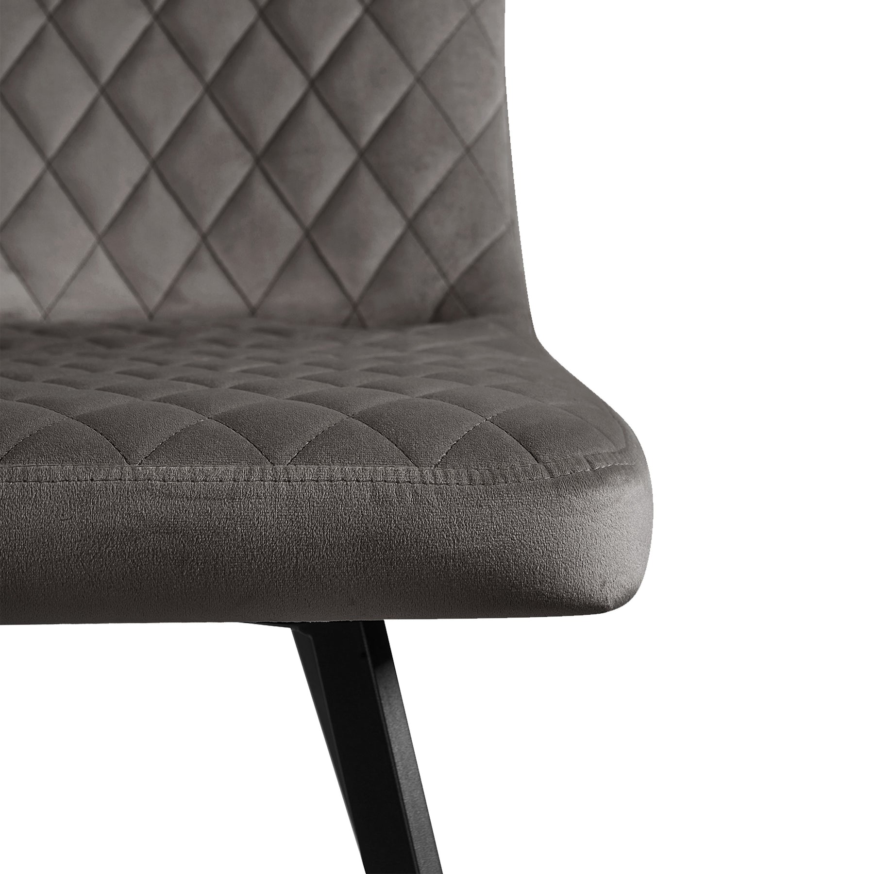 A grey upholstered chair with diamond stitching, positioned against a white background.