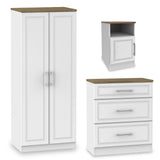 Three pieces of white furniture: a tall wardrobe with doors, a wall-mounted cabinet with one door, and a chest of drawers with a wooden top.