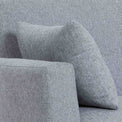 close up of the grey upholstered fabric and accent cushion on the Trom 3 Seater Sofa