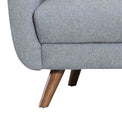 close up of the dark wood splayed legs on the Trom Grey Scandinavian style fabric armchair