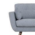 close up of the pocket sprung foam seat and curved armrests on the Trom Grey Scandinavian style fabric armchair