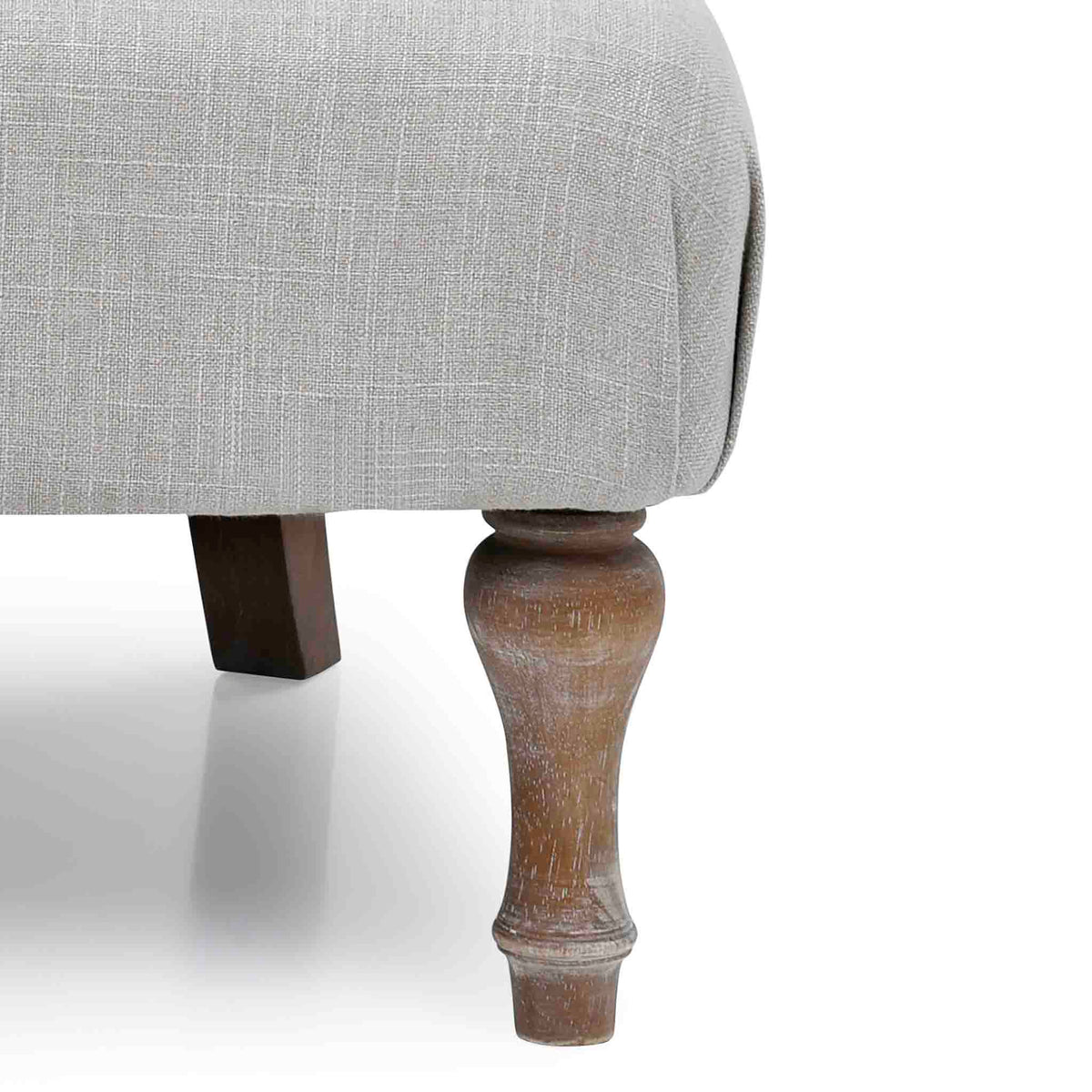 close up of the distressed antique wooden turned legs on the Cream Linen Fabric Bianca Armchair